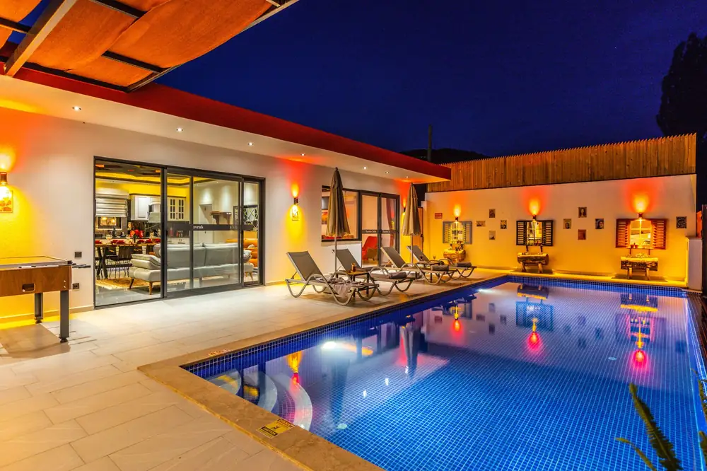 Backyard swimming pool with evening lighting